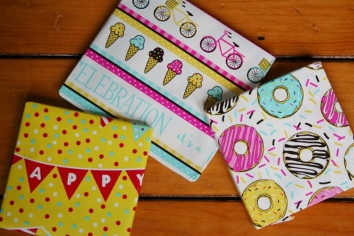 3 colorfully wrapped gifts in a pile